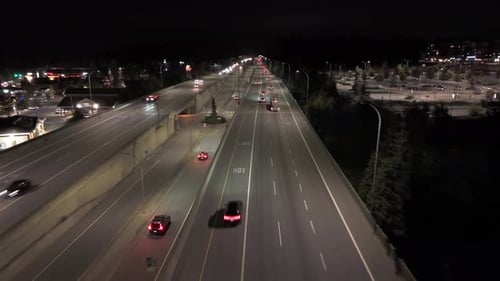 Car Drive at Multi-Lane Overpass at Night - Aerial Follow In