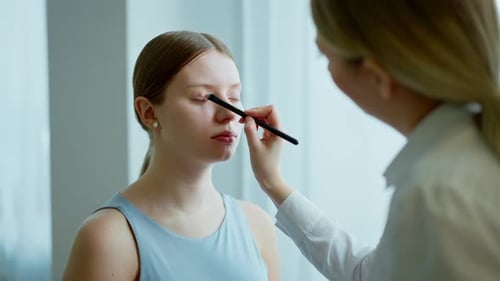 Makeup Artist Work in Her Beauty Studio Portrait of Woman Applying By Professional Make Up Master