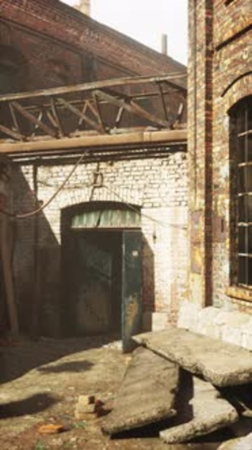 Sunlit Abandoned Factory Courtyard Vertical