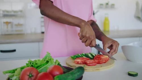 Woman Cuts Fresh Vegetables While Listening to Music