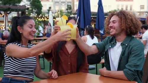 Friends Celebrate with Cocktails in Outdoor Garden
