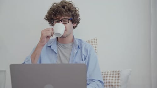 Young Adult Working on Laptop at Home