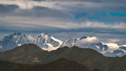 Italian Side Of The Piz Bernina Mountain Group With Moving Clouds