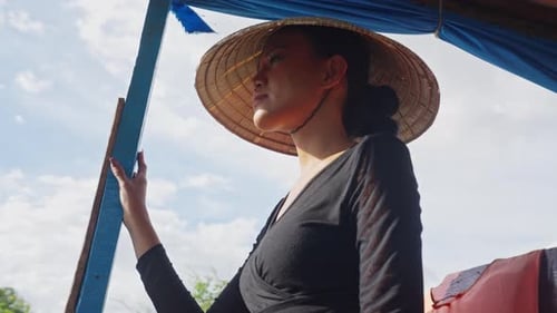 Woman Wearing Conical Hat on Boat During Daytime