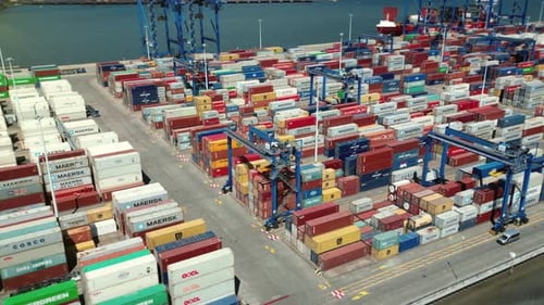 Cargo containers in a busy seaport. Aerial shot of shipping container storage.