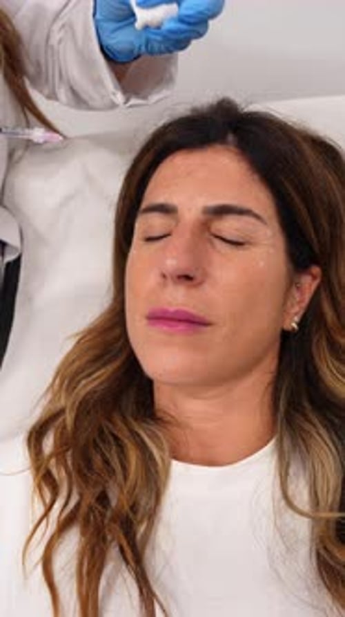 Adult Woman Receiving Cosmetic Injection at Medical Clinic