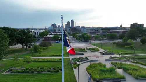 Aerial View of Iowa Flag Waving in City Park