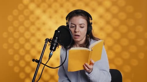 Woman Doing Voiceover Reading of Book to Produce Audiobook Studio Background