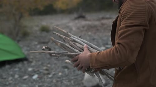 Hiker Tourist Traveler Man with Backpack Mountain Camping Fire Firewood Camp Tent Traveling Hiking