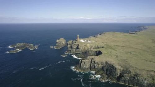Aerial view of lighthouse and cliffs by the ocean, Scotland.