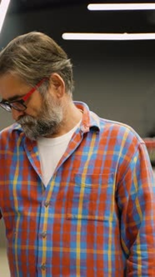 Senior Man Choosing Detergent in a Supermarket Cleaning Aisle