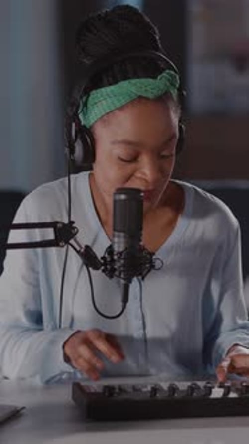 Woman Sings and Plays Keyboard into Microphone