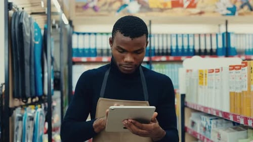 Portrait of African American Man Executive Typing on Smart Tablet in Store