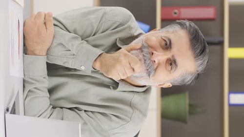 Vertical video of Unhappy office manager.