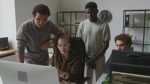 Diverse Programmers Team Discussing Software at Workplace