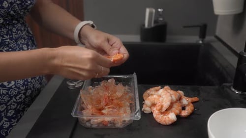 Woman Peeling Shrimp in Modern Kitchen