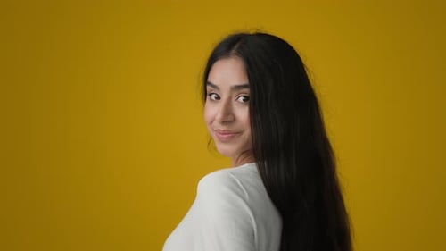 Portrait in Yellow Studio Health Female Brunette with Silky Shiny Soft Long Black Dark Hair Showing