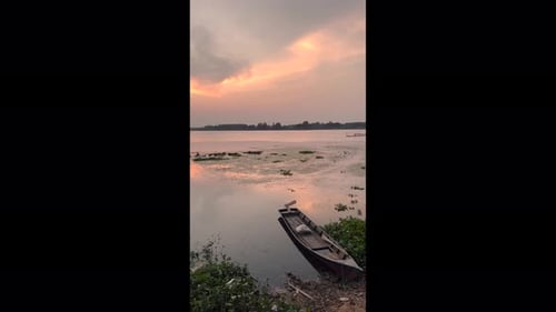 traditional fishing boats lines the lake's edge, their colorful hulls reflecting in the calm water.