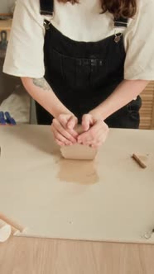 Woman Kneading Clay for Pottery Project in Studio