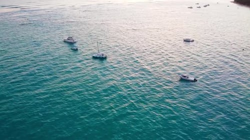 Aerial drone shot of the ocean in the Dominican republic passing boats that are floating