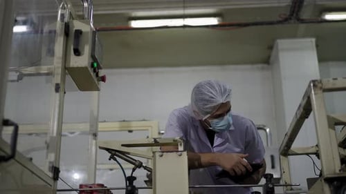 Employee working with packaging machine.