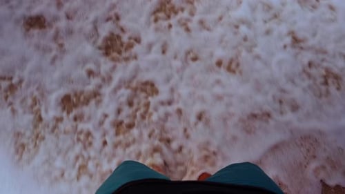 Feet Standing in Shallow Surf as Gentle Wave Washes Over Sand in First Person Slow Motion View,