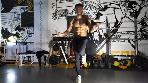 Muscular Afro American Sportsman Skipping with a Jump Rope at Sport Club Strong African Athlete with