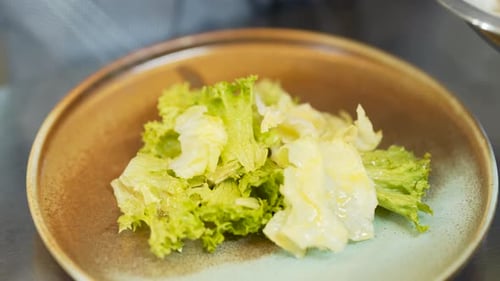 Chef Arranges Green Lettuce on a Decorative Plate