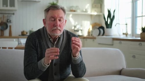 Senior Man with Headache at Home