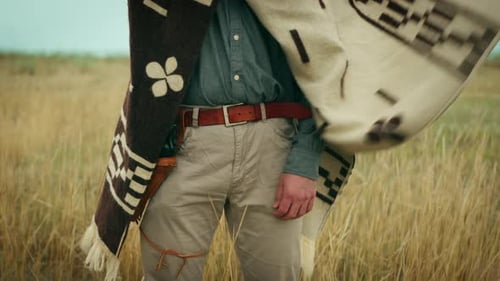 Cowboy with Gun in Rural Field