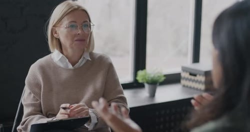 Professional Therapist Talking to Female Client Discussing Problem Working with Patient in Office