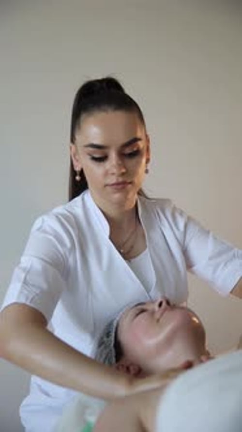 Facial Massage by Woman in White Lab Coat