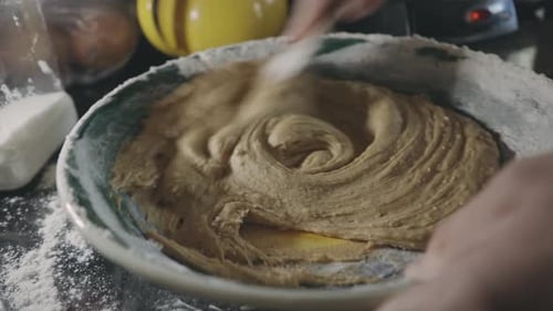 Mischen Sie dicken Plätzchenteig in einer Schüssel mit einem Holzlöffel - Nahaufnahme