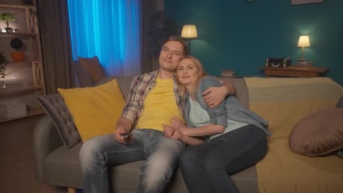 Loving Couple Relaxing at Home on Couch