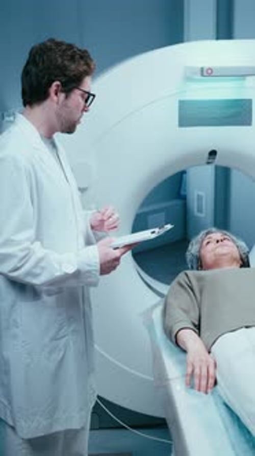 Male Radiologist Preparing Senior Female Patient for CT Scan Procedure