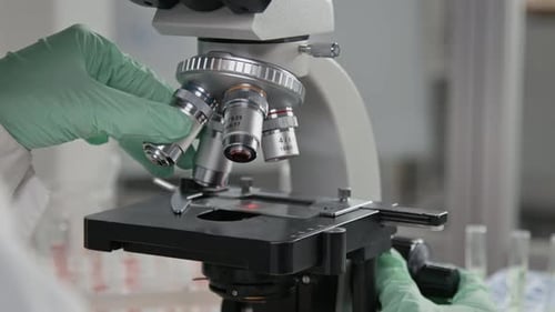 Close-up of Unrecognizable Scientist Using Microscope in Laboratory