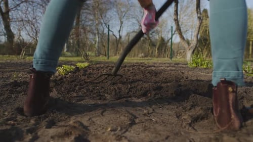Woman Working with Soil in Garden