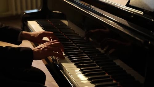 Man Playing Piano in Dark Room Close Up