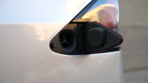 Plugging in Electric Car Charging Port Close Up