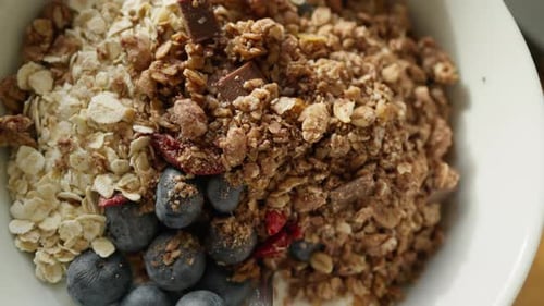 Detailed view of a nutritious granola bowl with oats, and berries.
