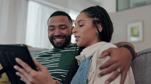 Happy Couple Relaxing with Tablet at Home
