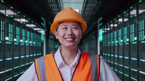 Close Up Of Asian Female Engineer While Standing With Arms Akimbo in Data Center