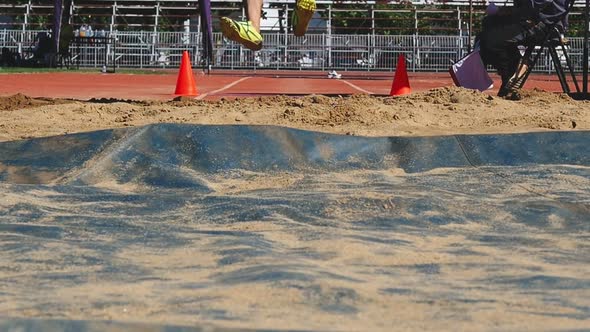 Sportsman landing into sandpit in long jump competition., Sports Stock ...