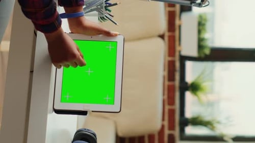 Vertical Video Office Manager Looking at Horizontal Greenscreen on Digital Device