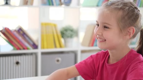 Little Girl Answering at Lesson in School