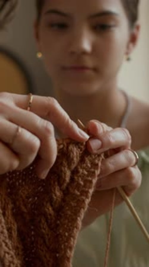 Girl Learning to Knit while Sitting next to Grandmother