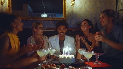 Happy friends celebrating in a cocktail bar