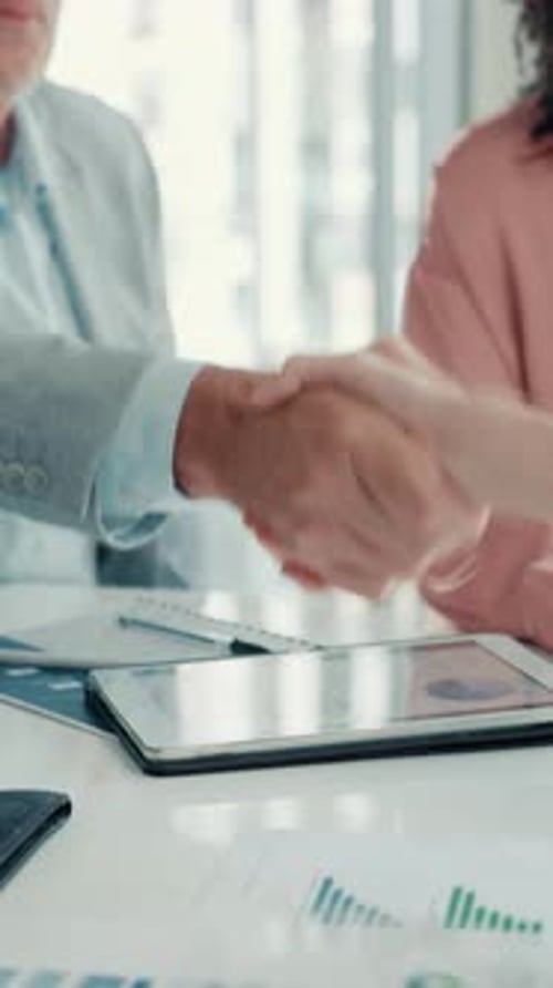 Business People Shaking Hands and Clapping at Desk