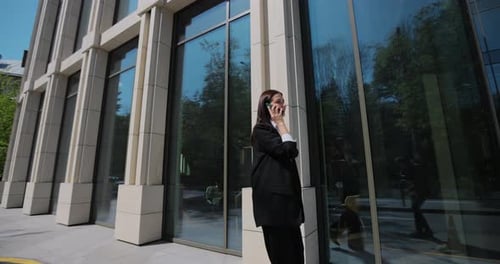 Businesswoman Talk Mobile Phone Near Office Building Woman is Talking By Mobile Phone and Walking