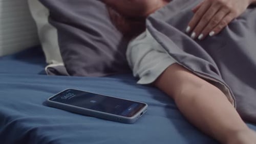 Woman Waking up Hearing Alarm Ringing on Phone